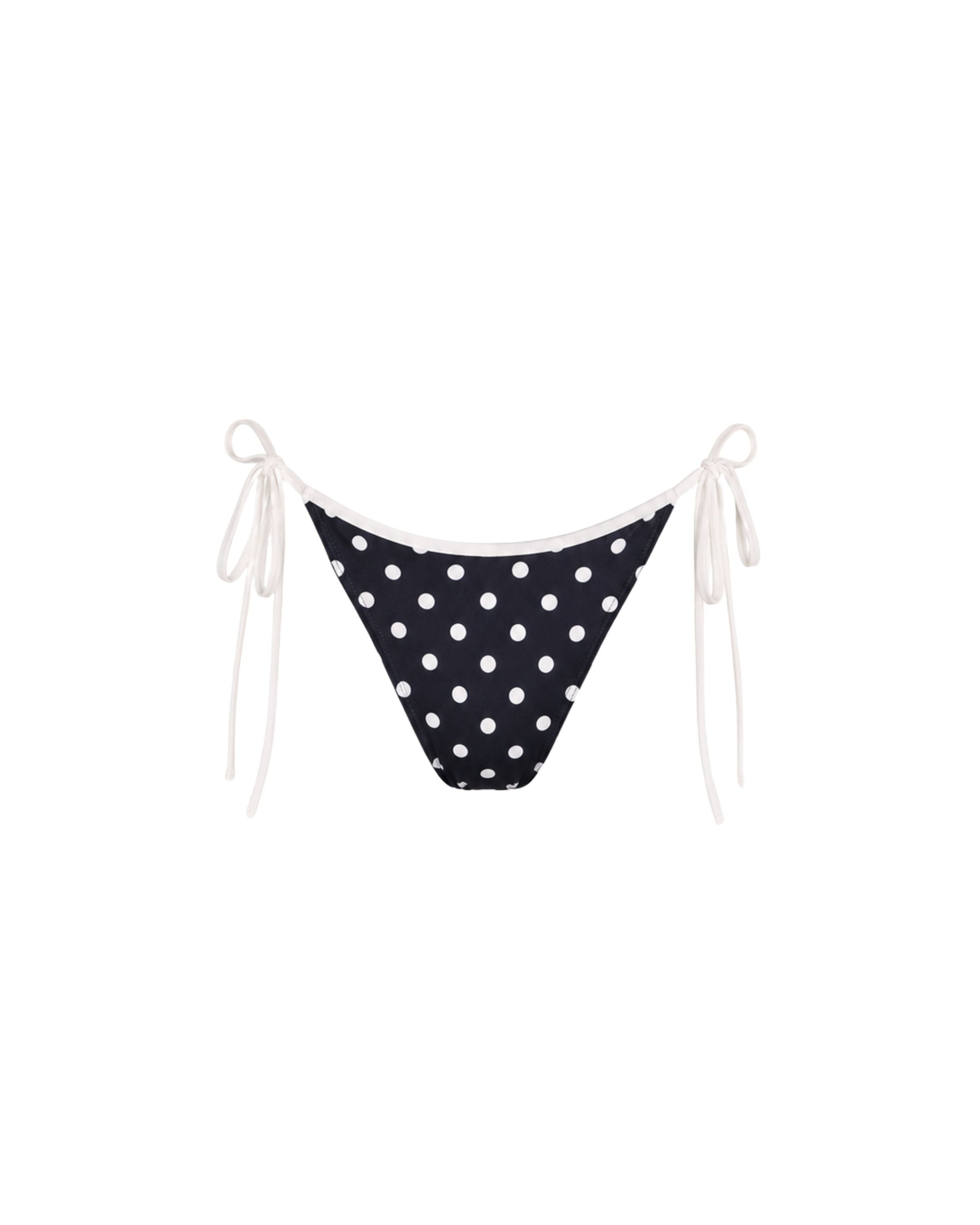 A black string bikini bottom with white polka dots and white side ties, shown against a plain white background.